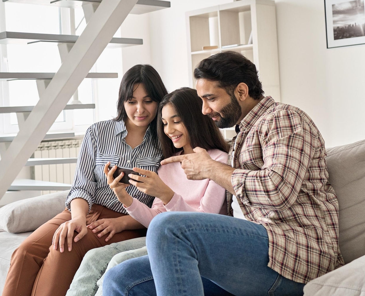 canva-happy-indian-family-daughter-phone
