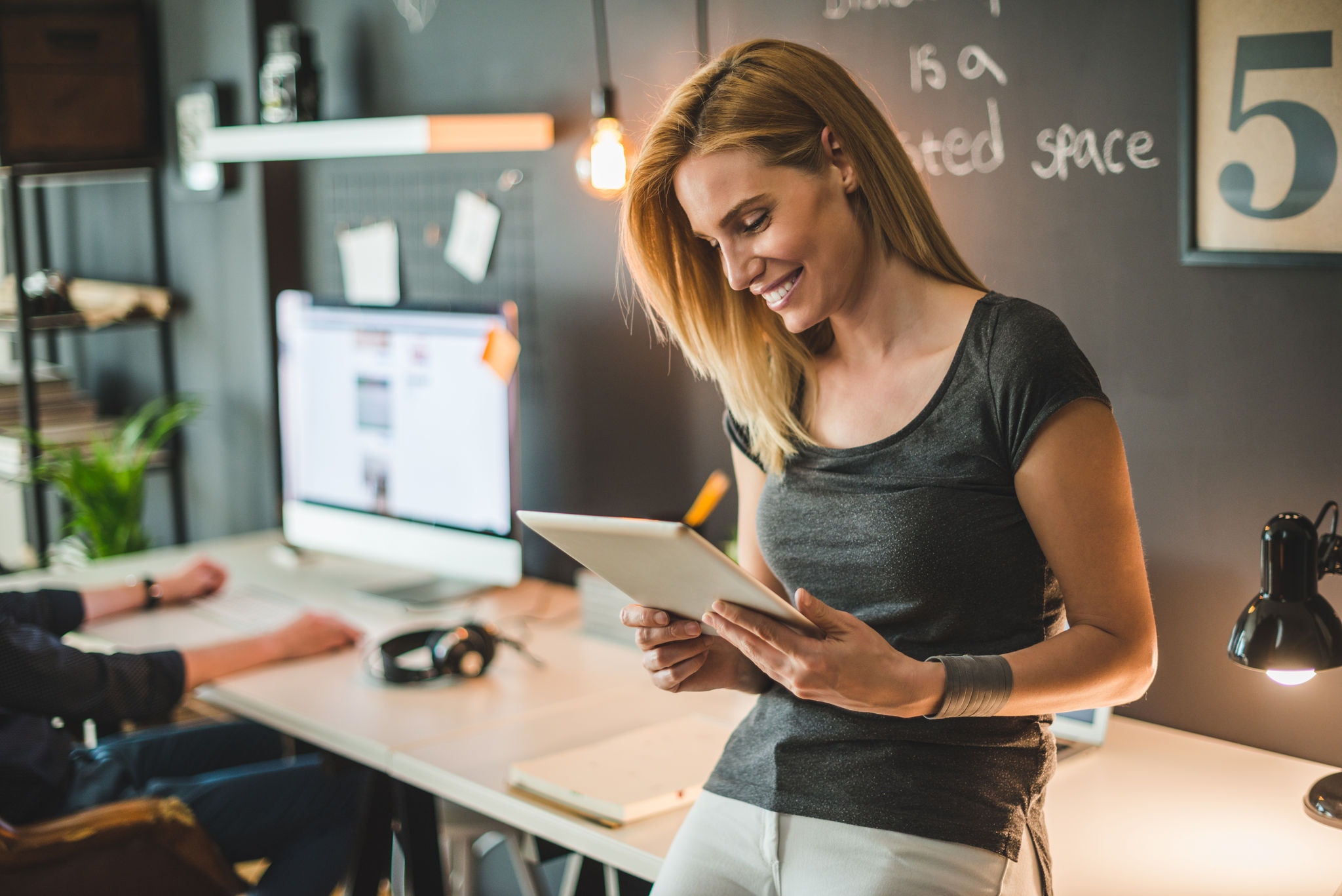 Businesswoman communicating with clients on a tablet
