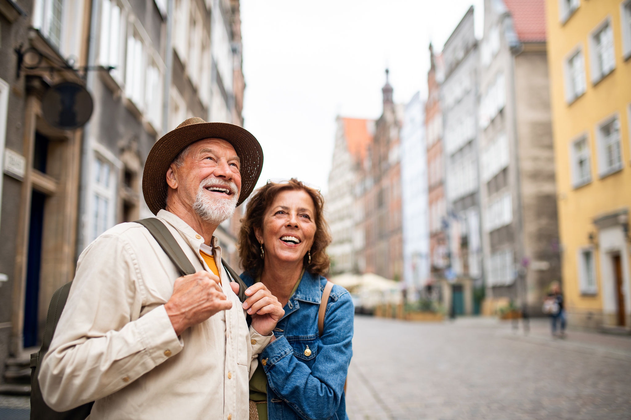 Happy couple of tourists exploring outdoors in a historic town
