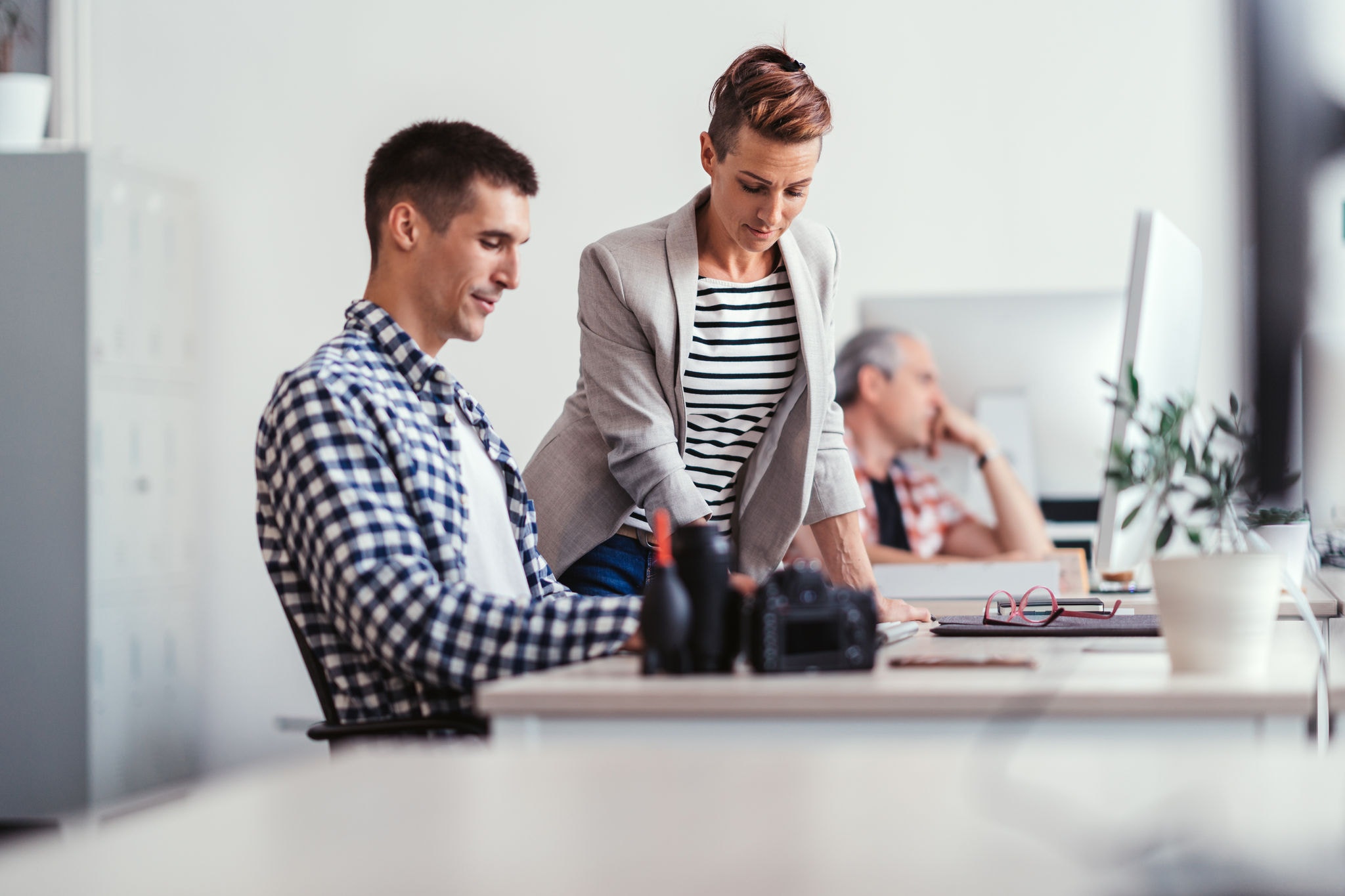 Two colleagues working together in a modern office