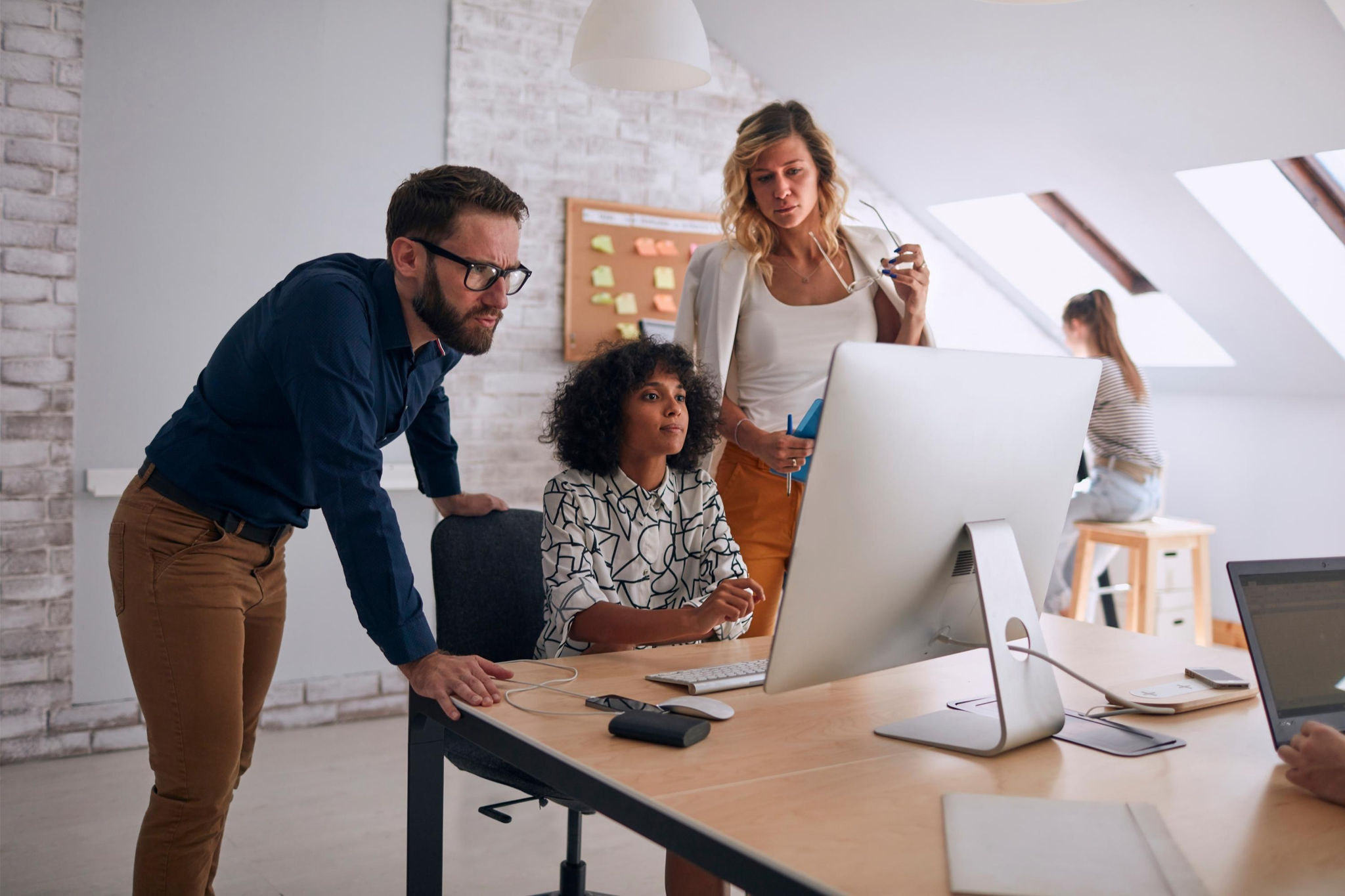 Co-workers looking at a computer screen 
