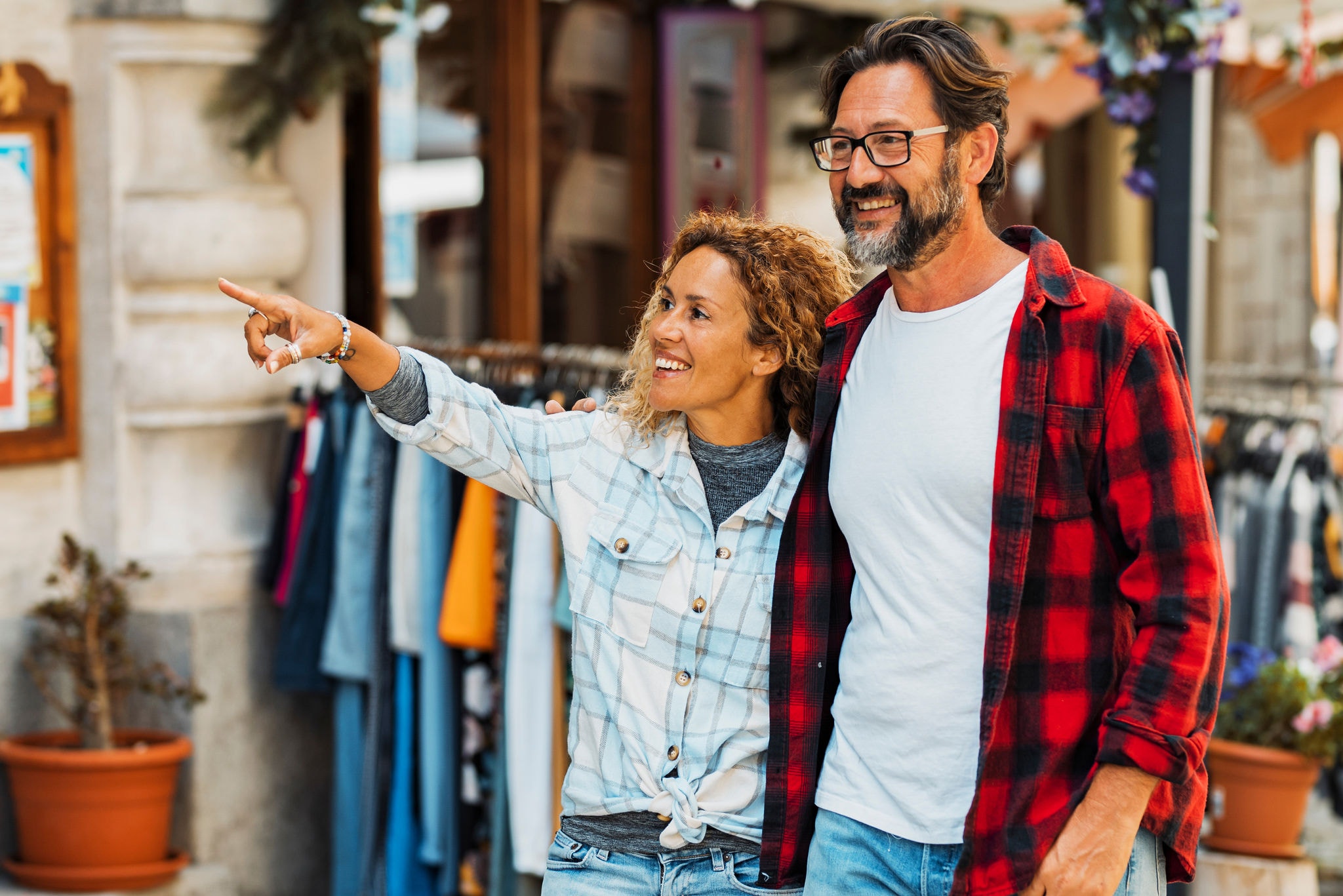 A couple of tourists strolling down the street, enjoying their shopping experience