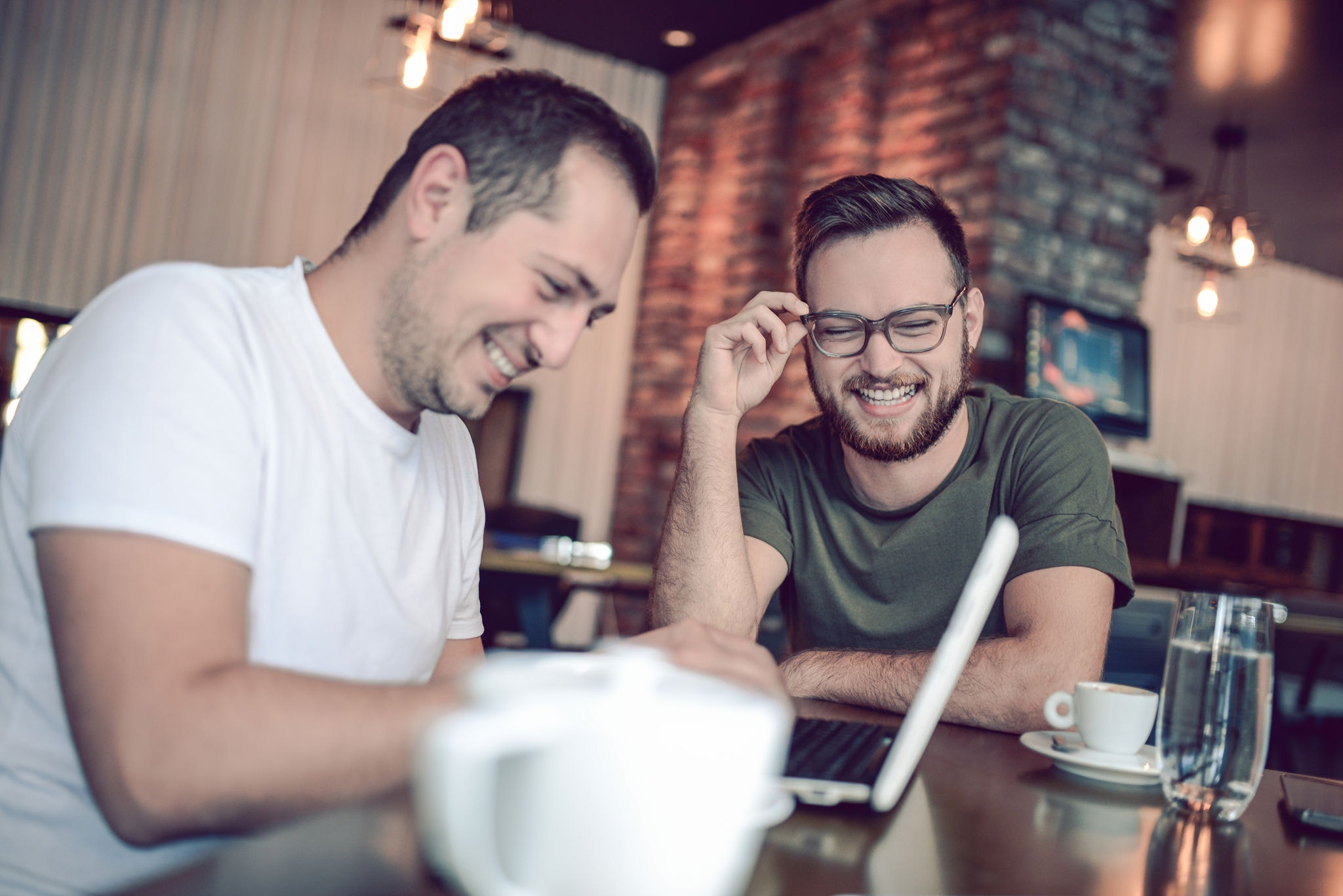 Male friends working at a cafe