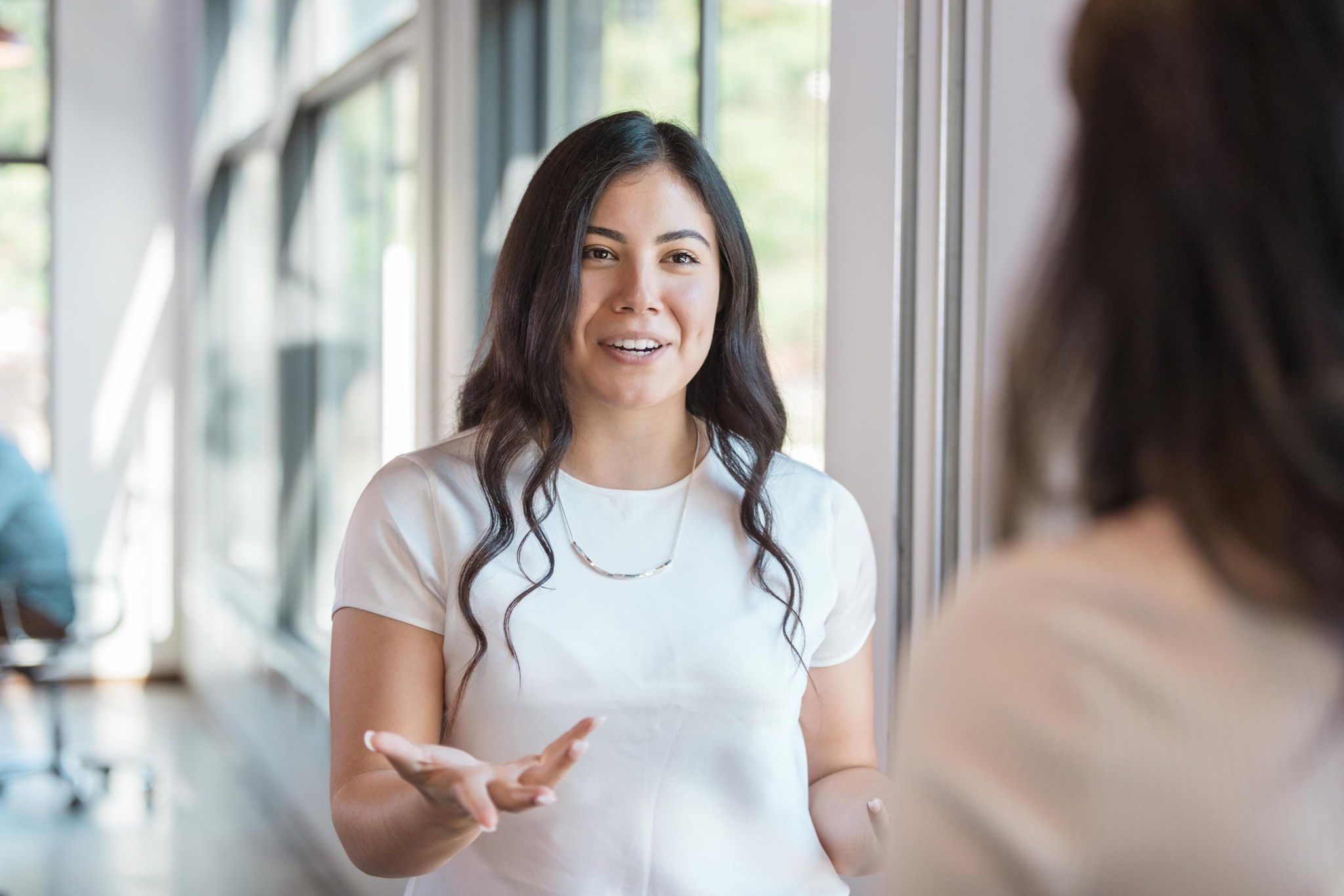 Young woman speaking to a friend