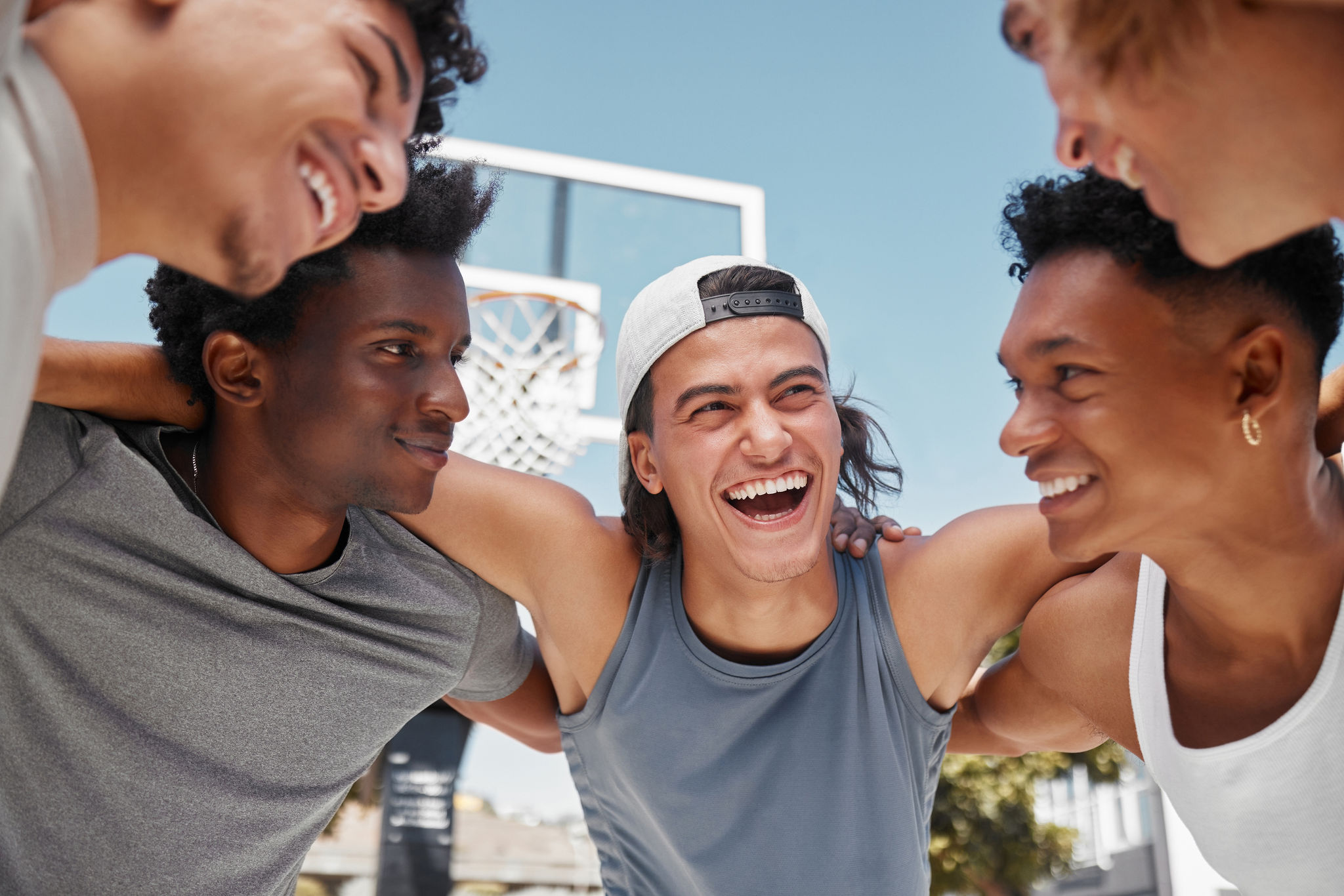 Group of male players huddling on the basketball court
