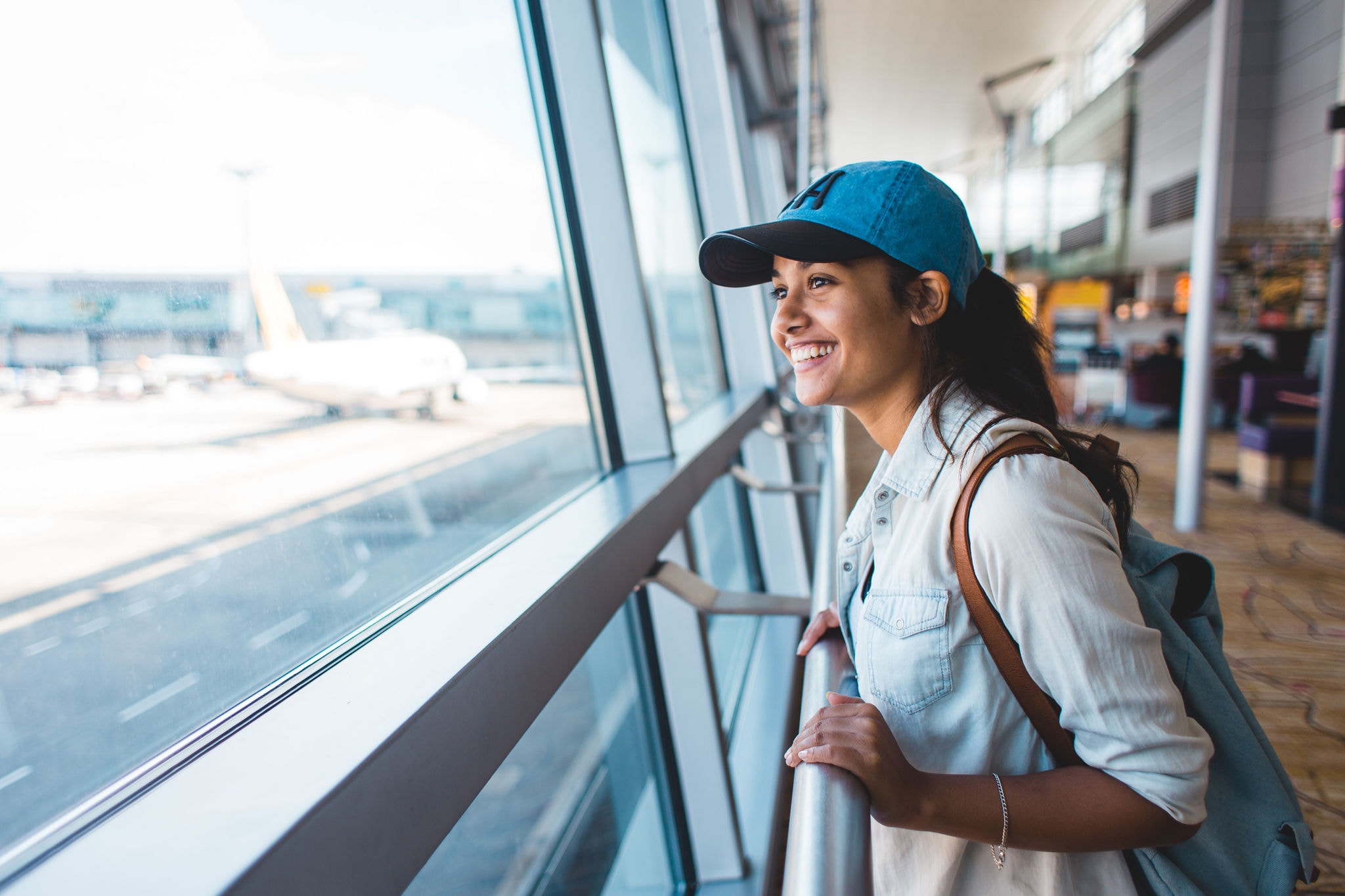 Young woman at airport waiting for airplane