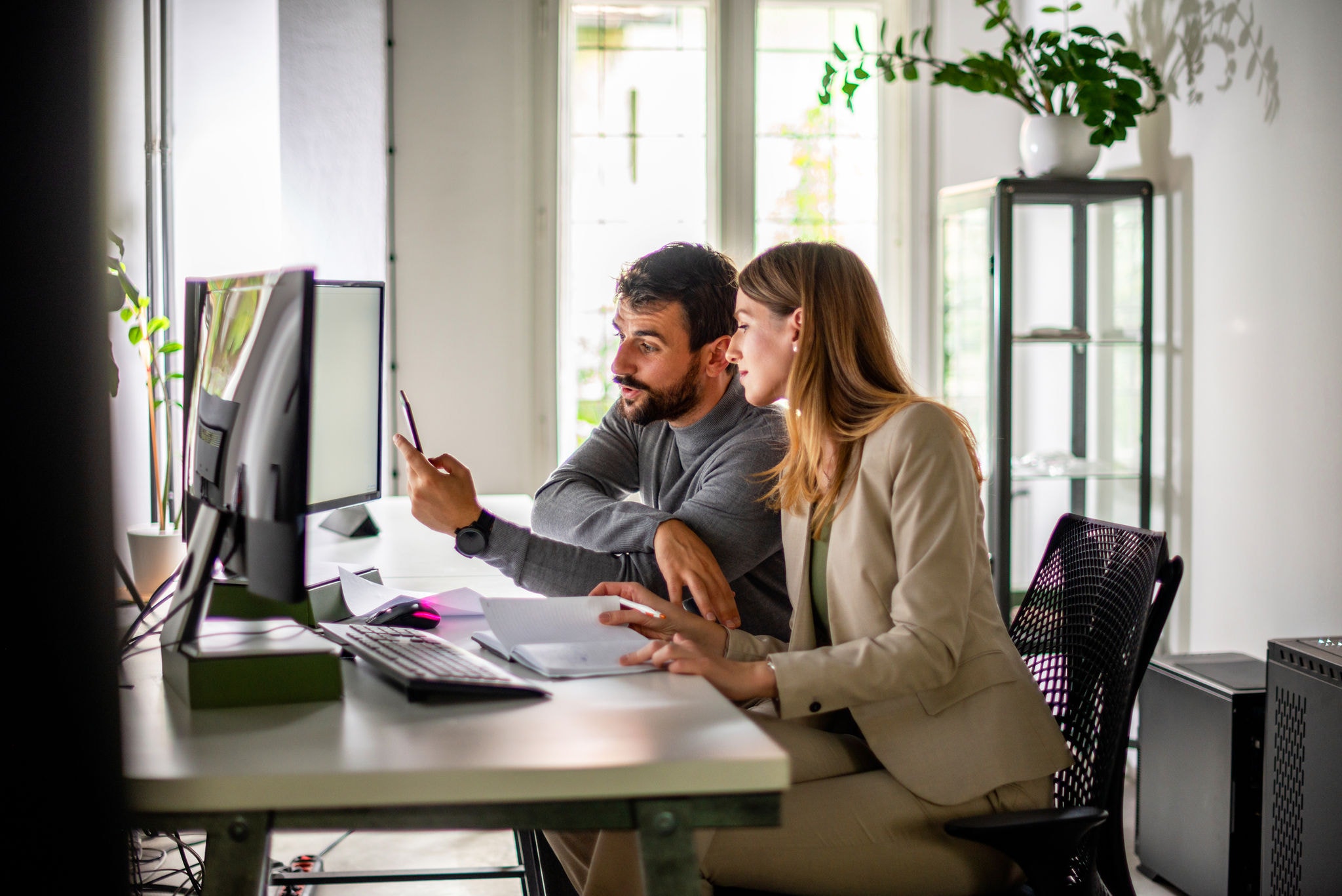 Two colleagues working together in a modern office