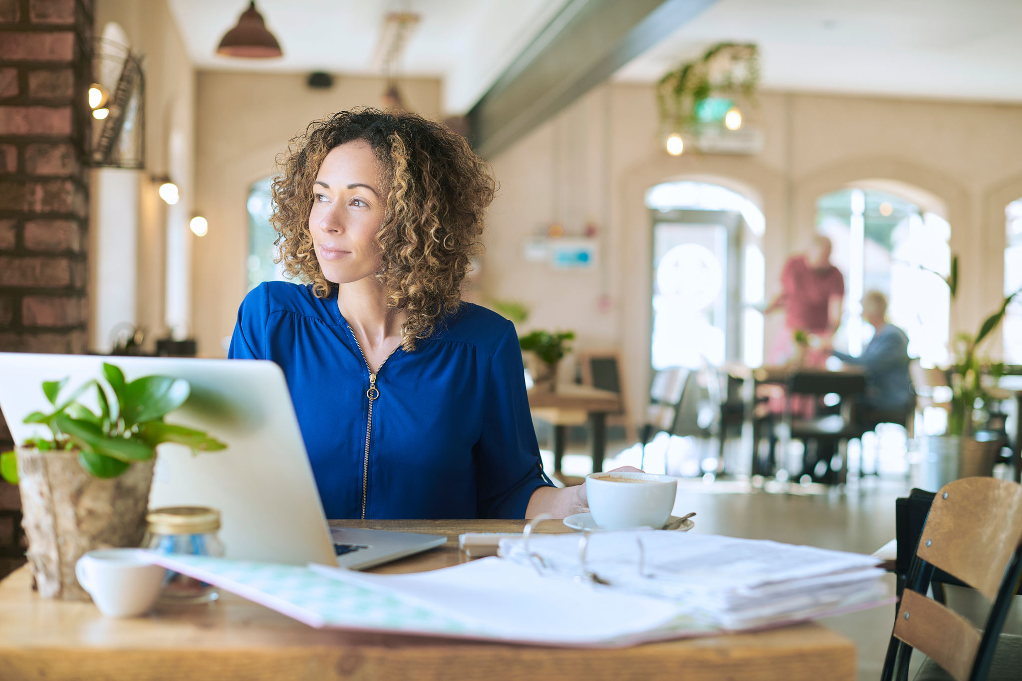 woman brings her work to the cafe