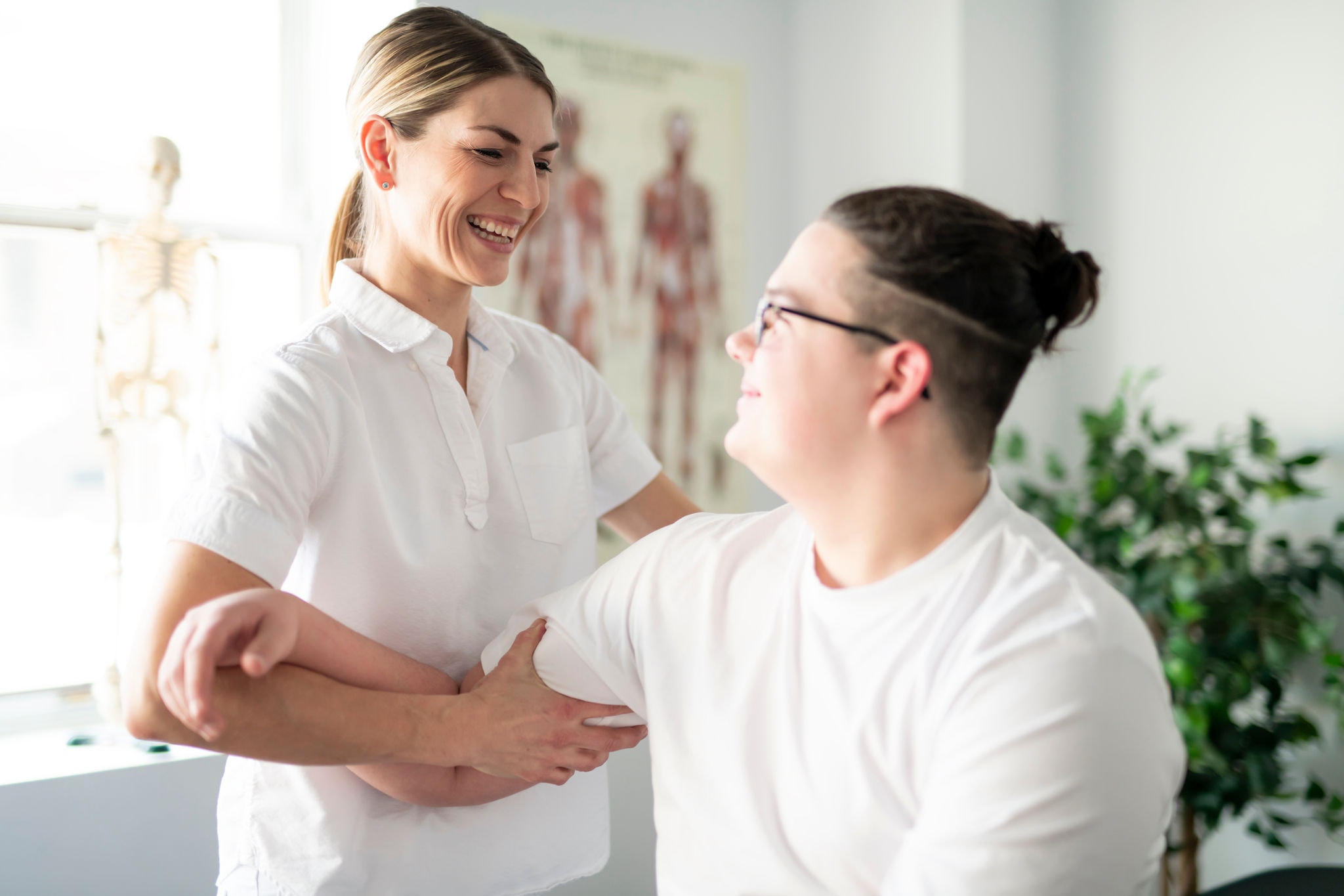Modern rehabilitation physiotherapy woman worker with client