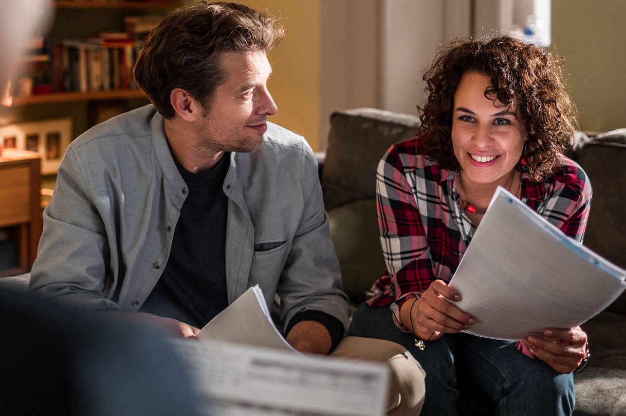 Financial adviser working at home with a young couple