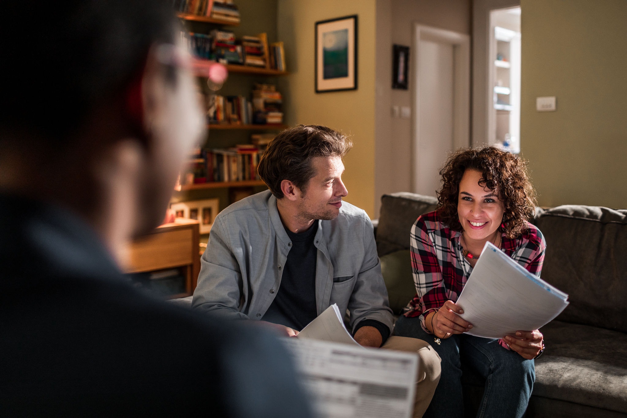 Financial adviser working at home with a young couple