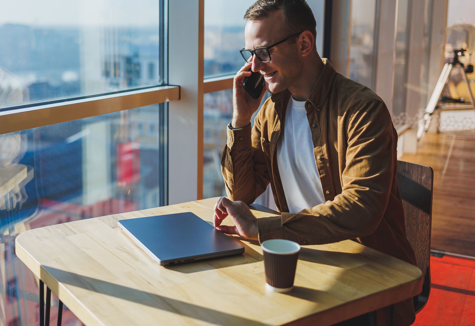 Couple of young men talking on the stairs of an office
