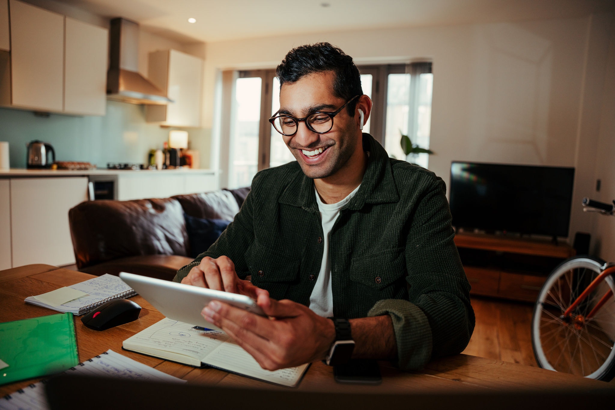 Young man video calling on his digital tablet at home